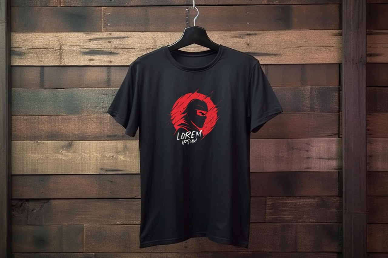 Black t-shirt with a red and white logo on a wooden wall
